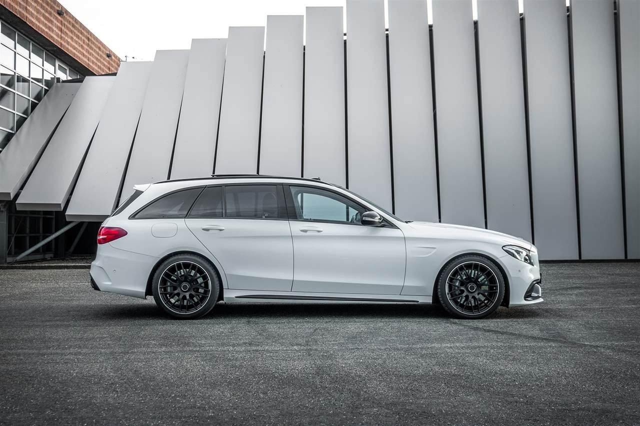 White Mercedes estate parked outside a modern building